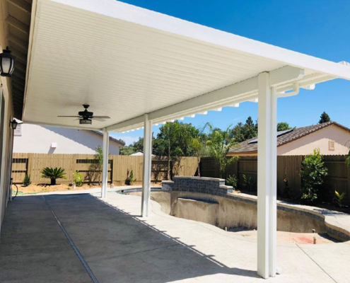 12x34 Attached, under eave mount, Durawood flatwood patio cover with Diamond ends. Color: Sierra Snow Trim Color: Sierra Snow  Electrical: Fan  Concrete: Three footings - Fair Oaks, CA
